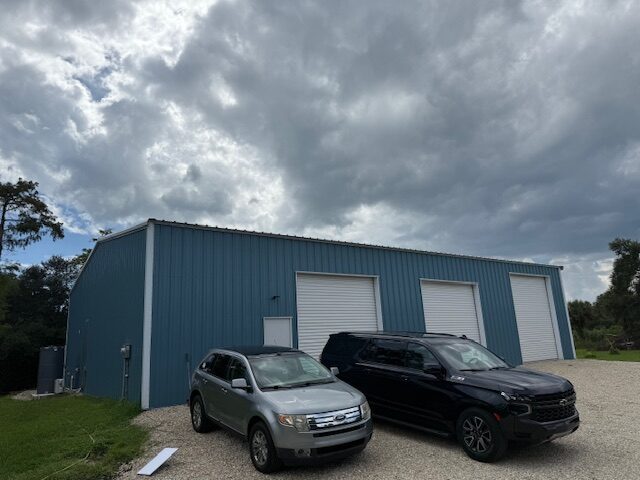 Atlas Automotive shop exterior and gravel parking area in Golden Gate Estates, Naples