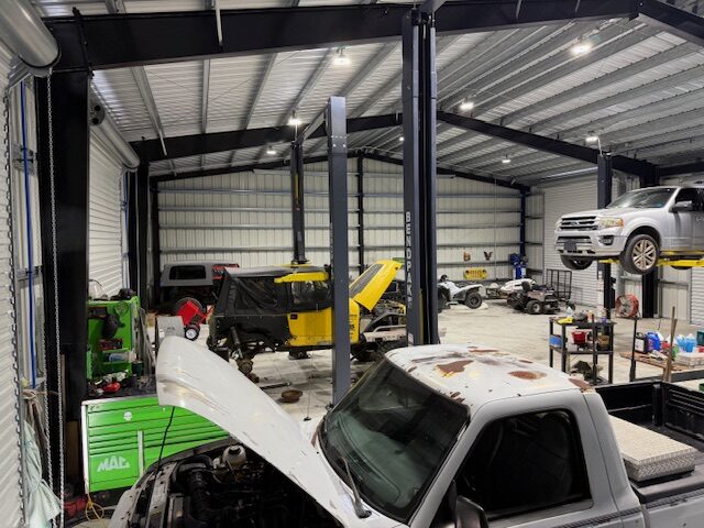 Tool cabinets, lifts and vehicles being repaired at Atlas Automotive